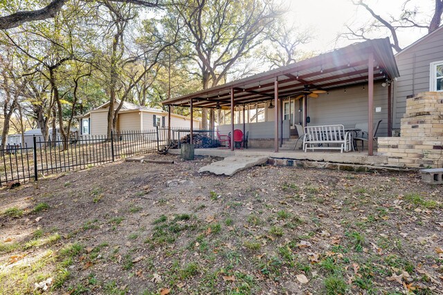 view of yard with a patio area and ceiling fan