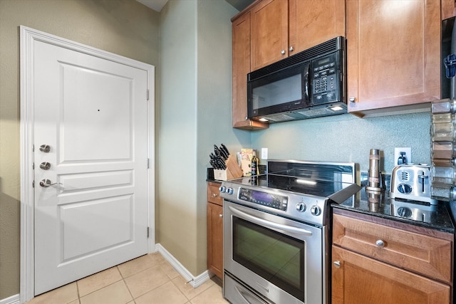 kitchen with light tile patterned floors and stainless steel electric range