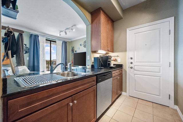 kitchen with sink, rail lighting, stainless steel dishwasher, light tile patterned flooring, and ornamental molding