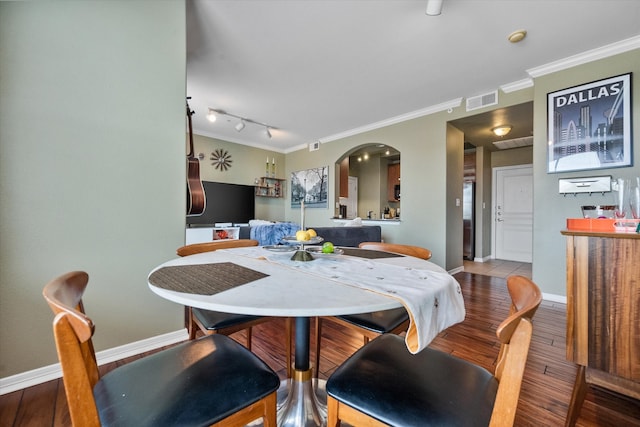 dining area featuring hardwood / wood-style flooring and ornamental molding