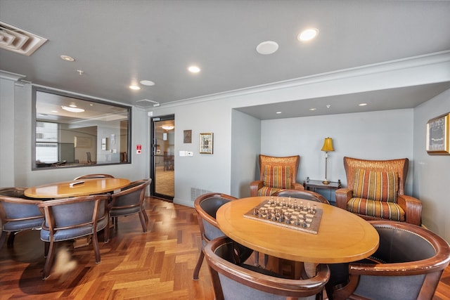 dining room featuring crown molding and light parquet flooring