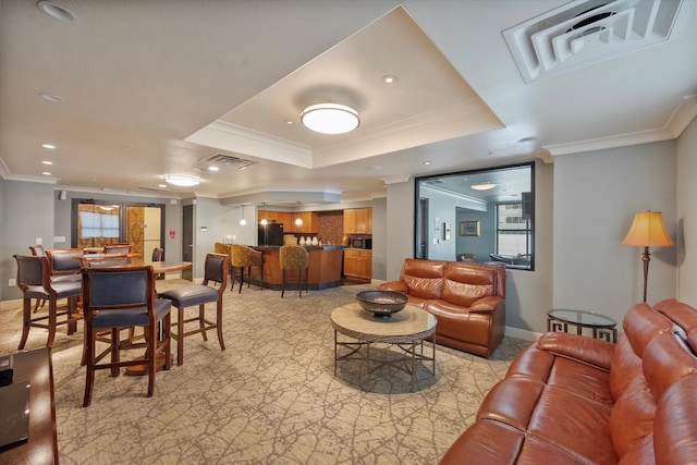 interior space with a tray ceiling and ornamental molding