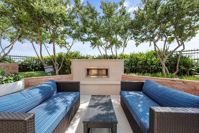 view of patio with an outdoor living space with a fireplace