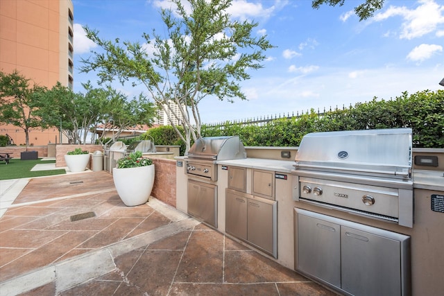 view of patio / terrace featuring an outdoor kitchen and a grill