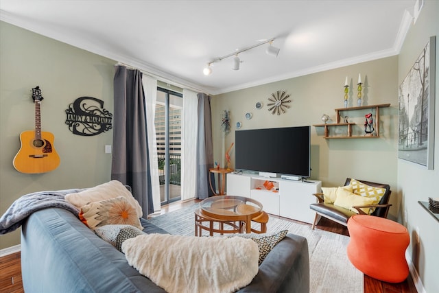 living room with hardwood / wood-style floors, ornamental molding, and track lighting