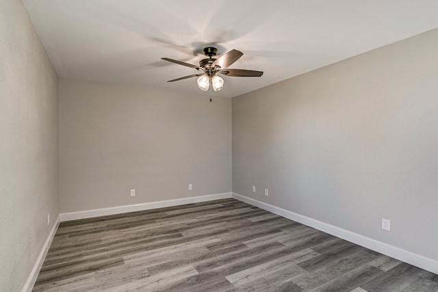 empty room with ceiling fan and dark hardwood / wood-style floors