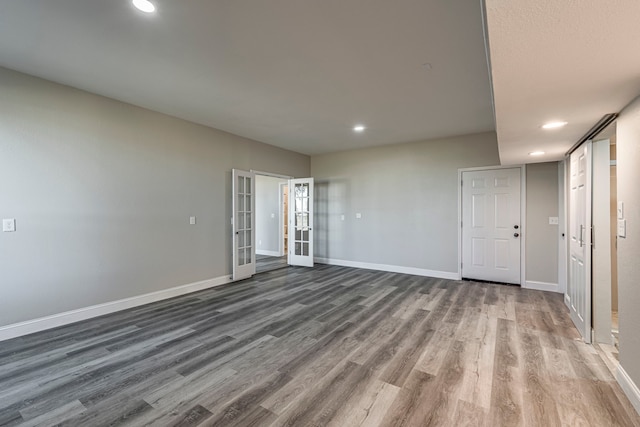 spare room with french doors and hardwood / wood-style flooring