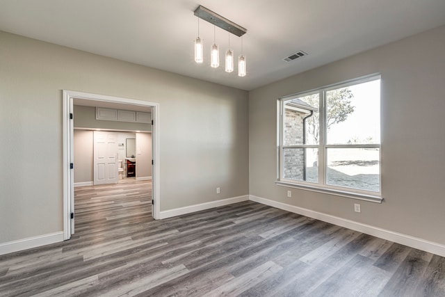 empty room with hardwood / wood-style flooring