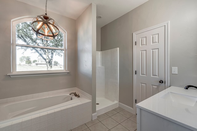 bathroom with tile patterned floors, plenty of natural light, separate shower and tub, and vanity