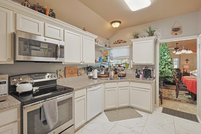 kitchen with white cabinetry, sink, vaulted ceiling, and appliances with stainless steel finishes