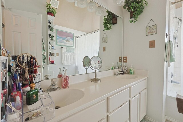 bathroom featuring vanity and shower / tub combo with curtain