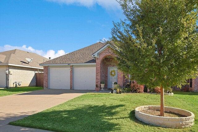 view of front of property with a front yard and a garage