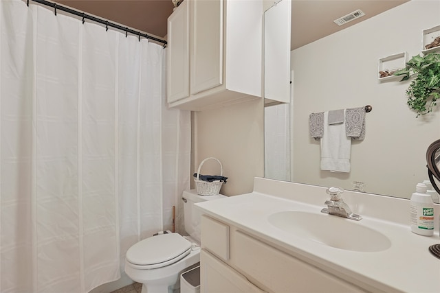 bathroom featuring curtained shower, vanity, and toilet