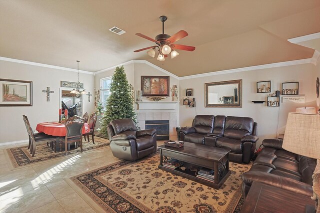 living room with ceiling fan, a fireplace, light tile patterned flooring, and crown molding