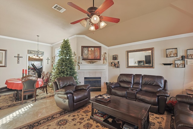 living room with a fireplace, lofted ceiling, crown molding, and ceiling fan with notable chandelier