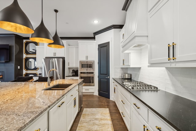 kitchen featuring pendant lighting, white cabinetry, sink, and stainless steel appliances