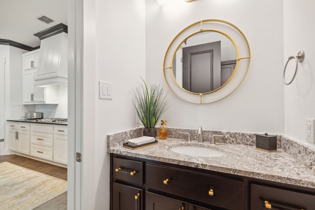 bathroom with vanity and hardwood / wood-style flooring