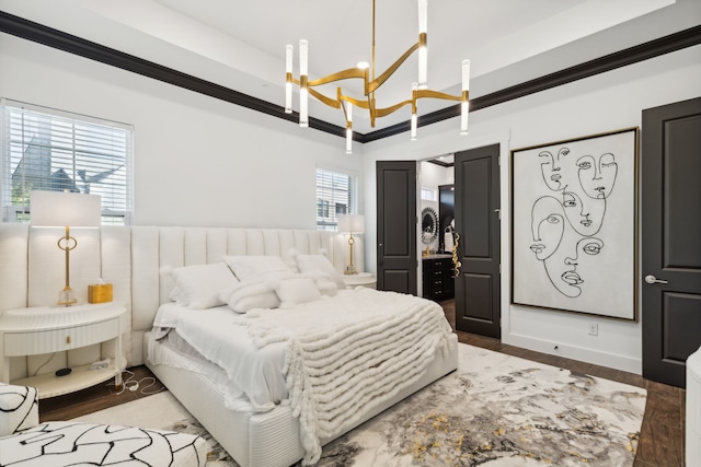 bedroom featuring a chandelier, wood-type flooring, multiple windows, and crown molding