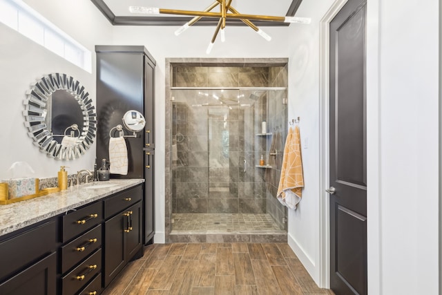 bathroom featuring vanity, an enclosed shower, and crown molding