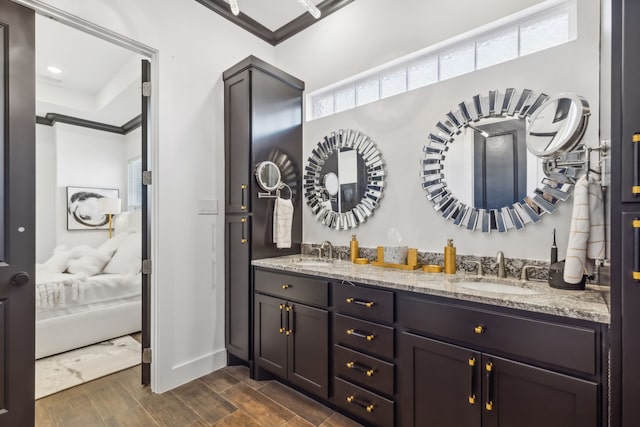 bathroom with hardwood / wood-style floors, vanity, and ornamental molding