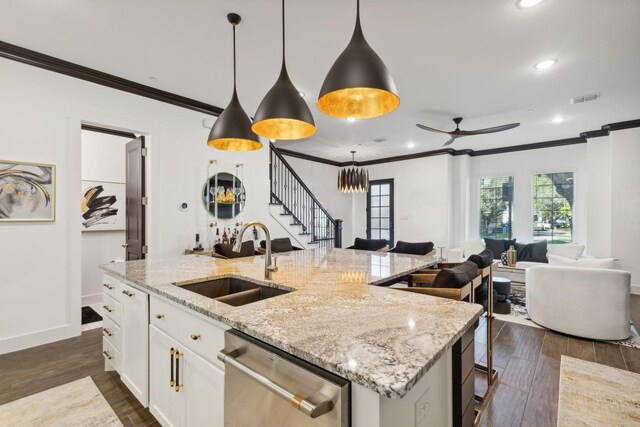 kitchen featuring dark wood-type flooring, hanging light fixtures, white cabinets, and stainless steel dishwasher