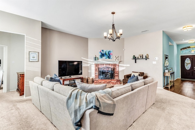 living room with a fireplace, hardwood / wood-style floors, and a notable chandelier