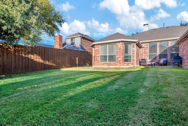 back of property featuring a yard and a patio