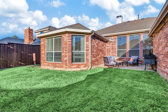 back of house with a yard, a patio, and an outdoor hangout area