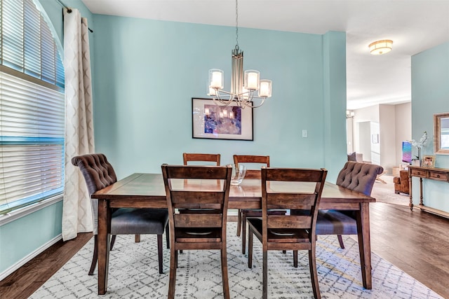 dining room with a notable chandelier and wood-type flooring