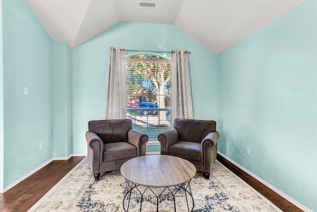 living area with hardwood / wood-style flooring and lofted ceiling