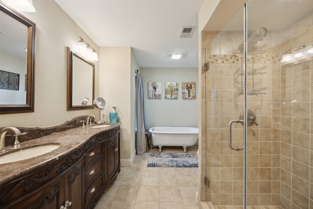 bathroom featuring tile patterned flooring, vanity, and a shower with door