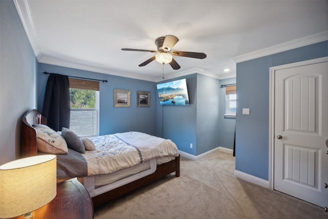 carpeted bedroom with ceiling fan and ornamental molding