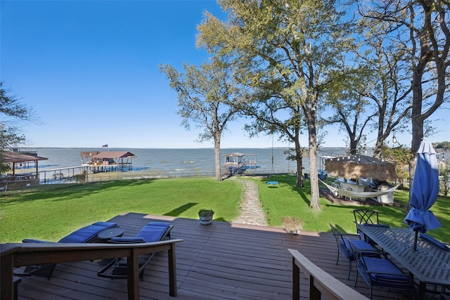 view of dock featuring a lawn and a deck with water view