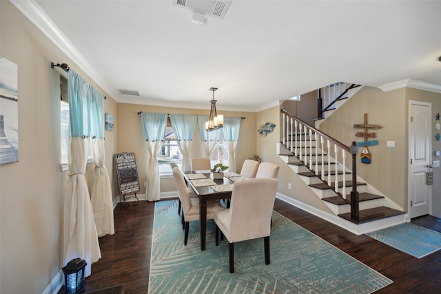 dining room featuring crown molding, dark hardwood / wood-style flooring, and a notable chandelier