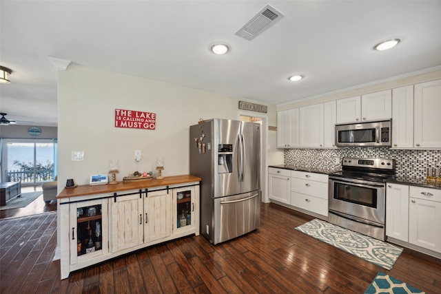 kitchen with white cabinets, dark hardwood / wood-style floors, and appliances with stainless steel finishes