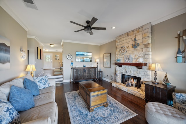 living room featuring a stone fireplace, ceiling fan, dark hardwood / wood-style flooring, and ornamental molding