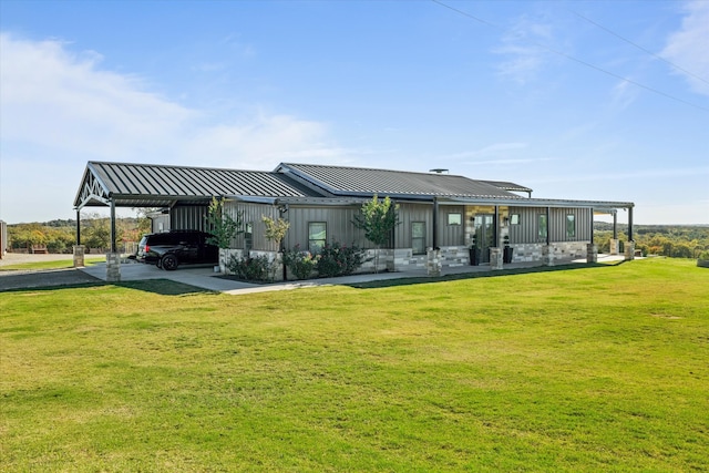 back of property featuring a carport and a yard