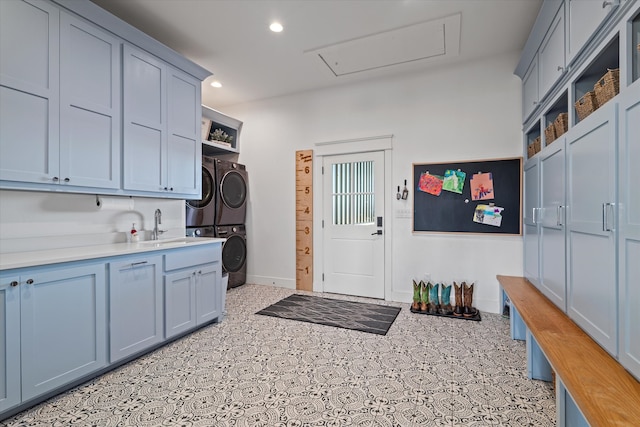 kitchen with stacked washing maching and dryer and sink