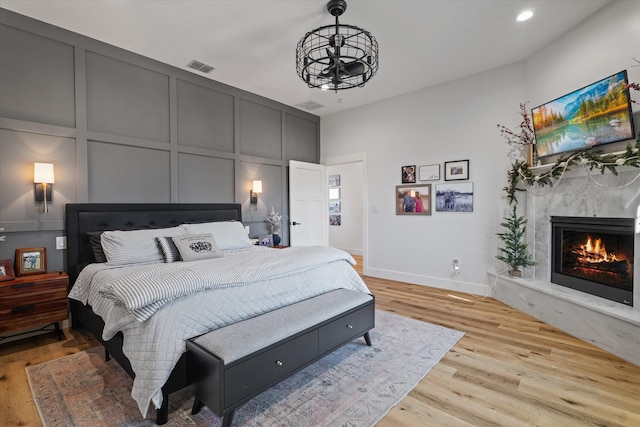 bedroom featuring a notable chandelier and light wood-type flooring