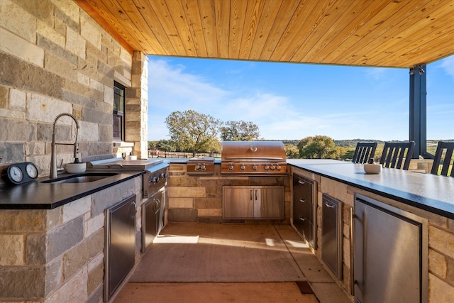 view of patio with area for grilling, sink, and grilling area