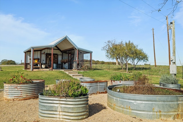 exterior space featuring a lawn, an outbuilding, and a rural view