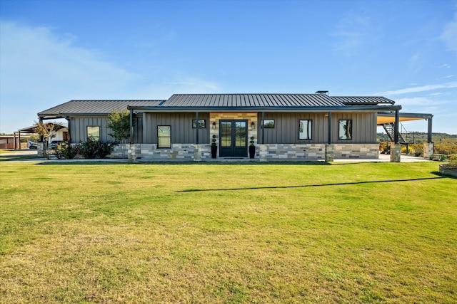 rear view of house with a yard and french doors