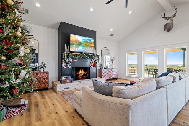 living room with a fireplace, high vaulted ceiling, light hardwood / wood-style flooring, and ceiling fan