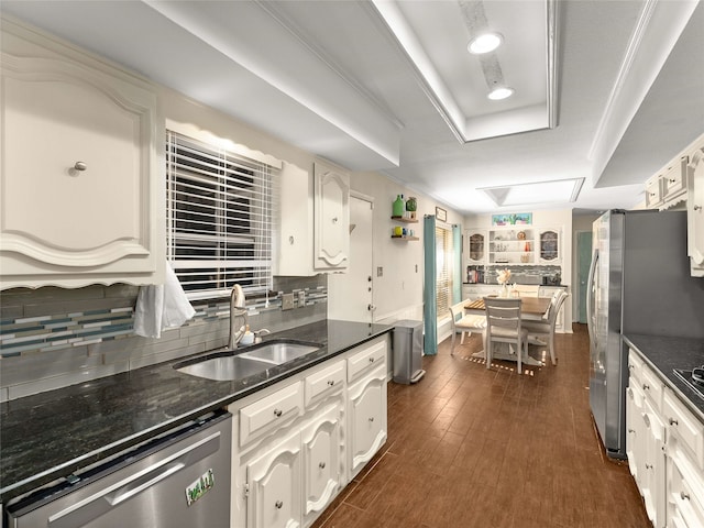 kitchen featuring dark wood-type flooring, white cabinets, stainless steel dishwasher, and sink