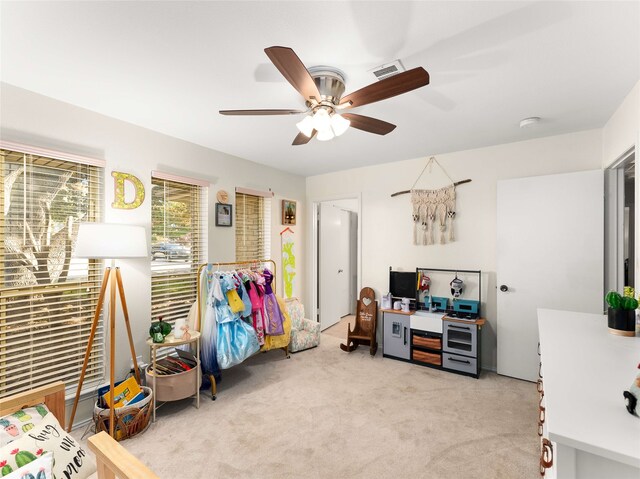 carpeted home office with ceiling fan