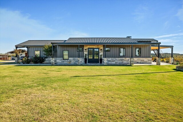 back of house with a yard and french doors