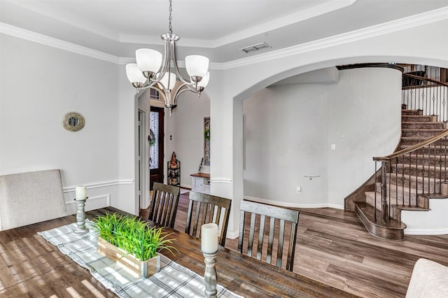 carpeted bedroom featuring a raised ceiling, ceiling fan, and crown molding