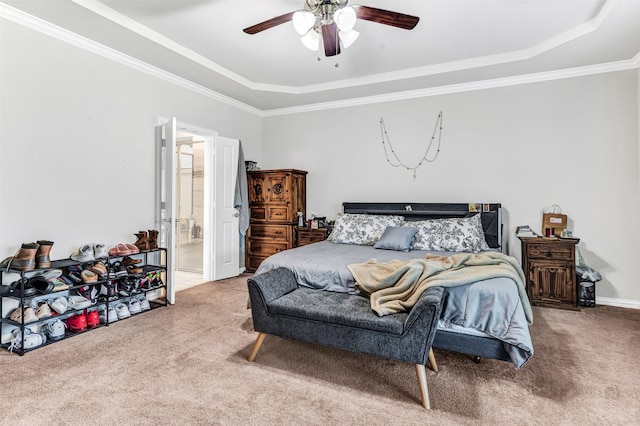 bedroom featuring ensuite bathroom, a raised ceiling, carpet floors, and ceiling fan