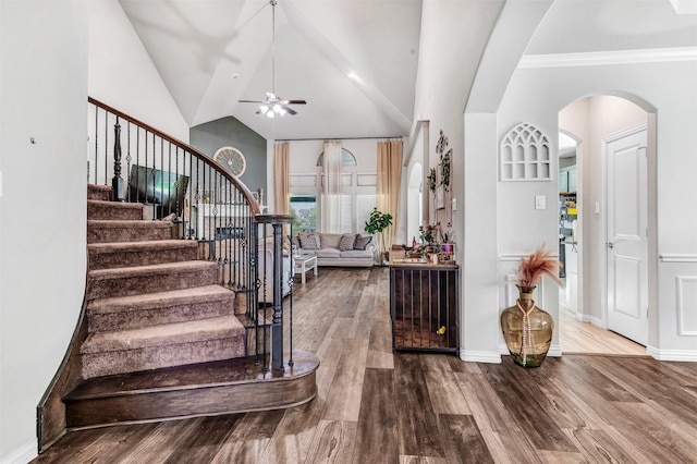 entrance foyer featuring vaulted ceiling, hardwood / wood-style flooring, ceiling fan, and ornamental molding