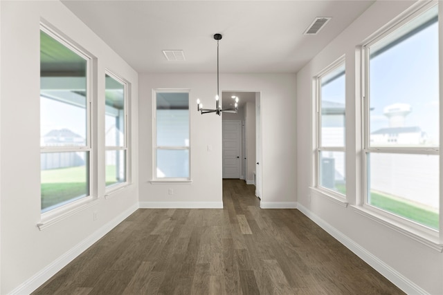 3304 Andesite Rd, Mckinney, TX 75071 - unfurnished dining area featuring a chandelier, dark wood-style floors, healthy amount of natural light, and baseboards